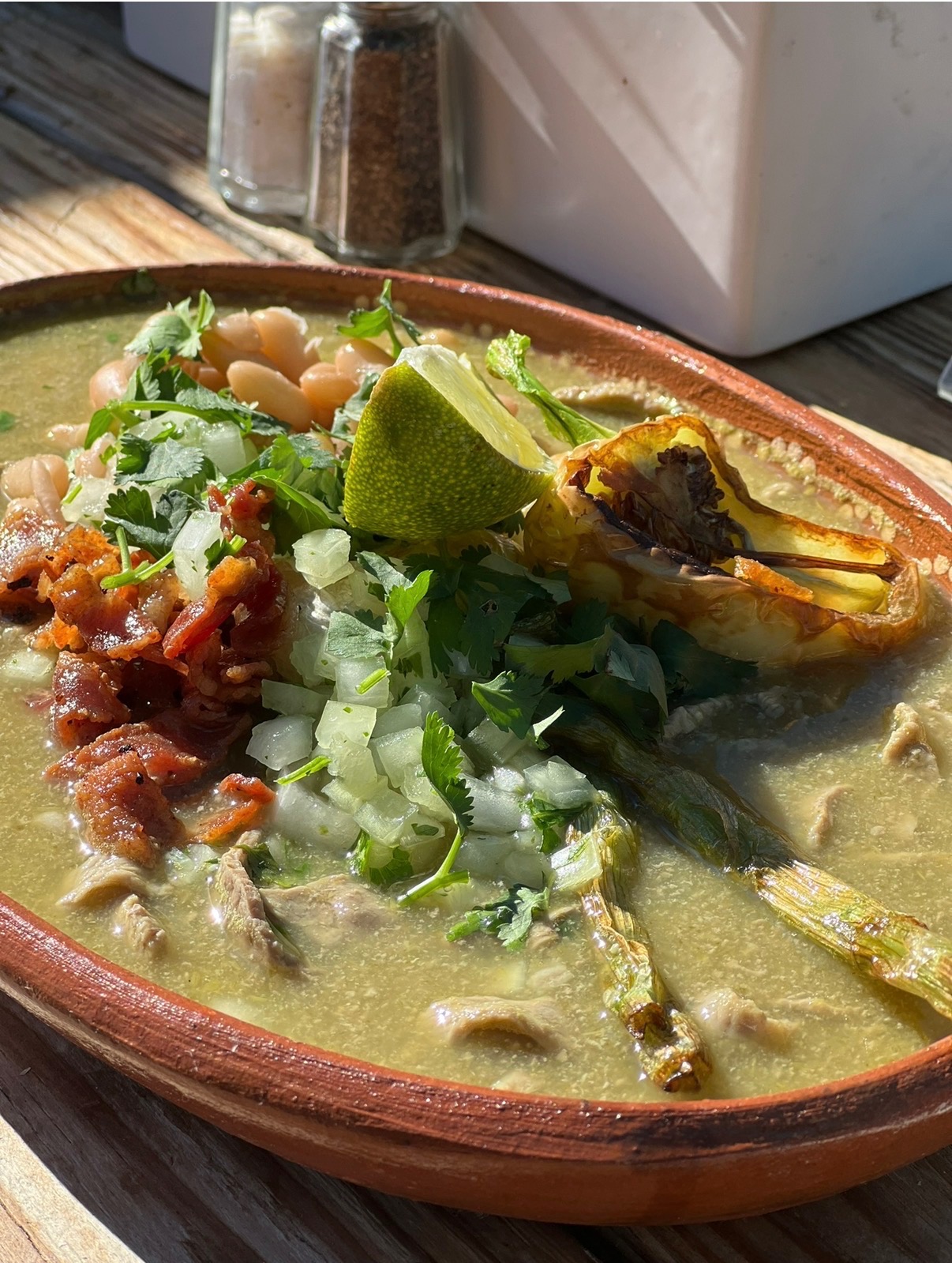 Felipe’s chile verde served with beans, onion, cilantro, and lime